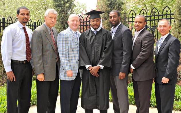 Junior Cadougan poses for a photo with Marquette's coaching staff after graduation. (Courtesy: Marquette Athletics via Twitter)