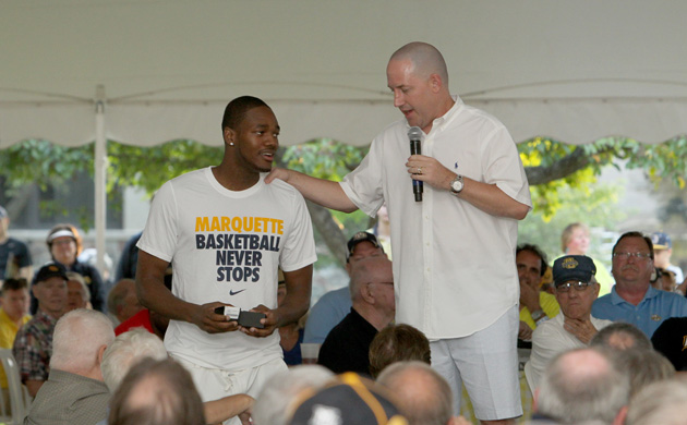Steve Taylor receives his Elite 8 ring from Buzz Williams at the Marquette BBQ on June 26. (Marquette Images)